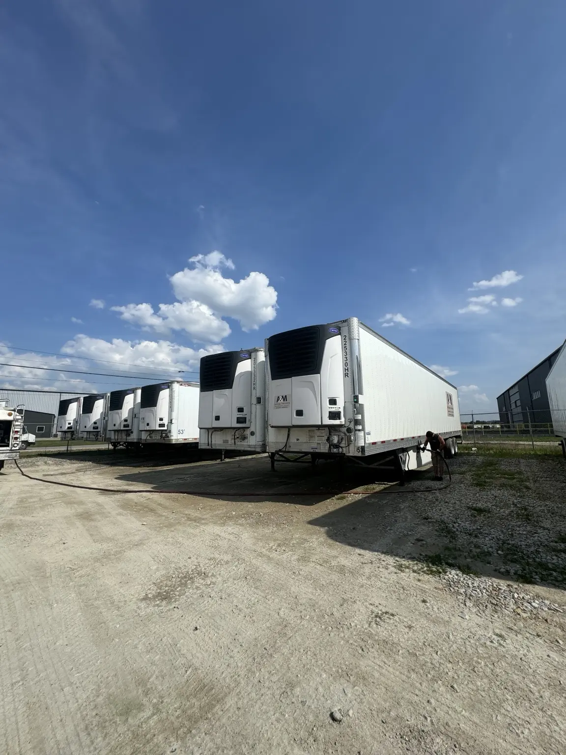 Holliday's team member fueling refrigerated trailers at a fleet yard
